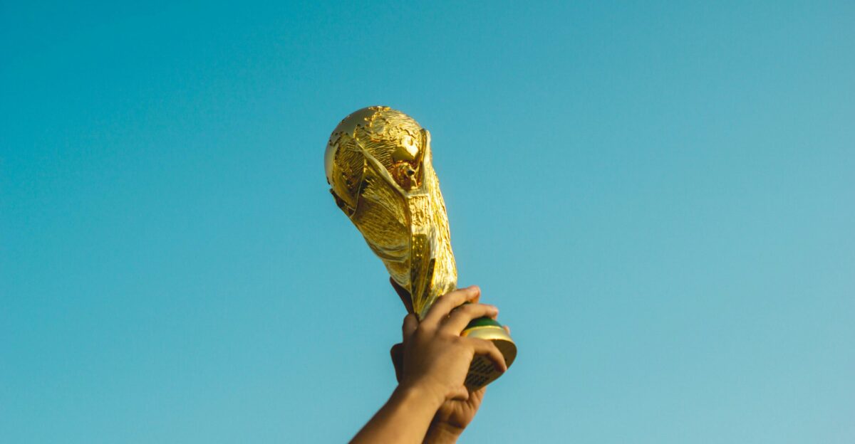 person holding gold trophy