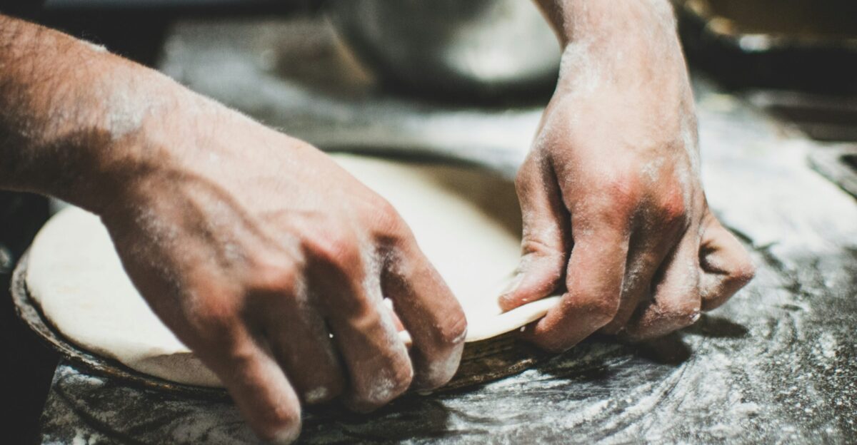 a person is kneading dough on a table