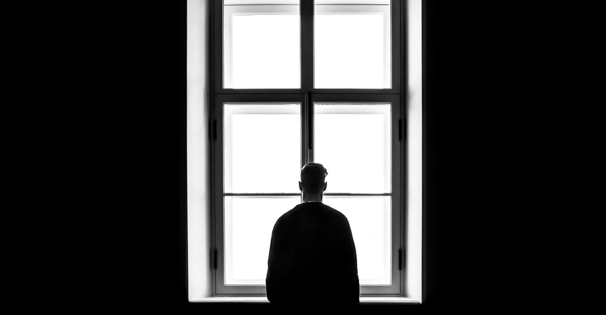 man standing in front of the window