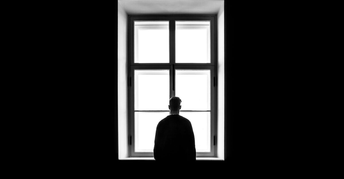 man standing in front of the window