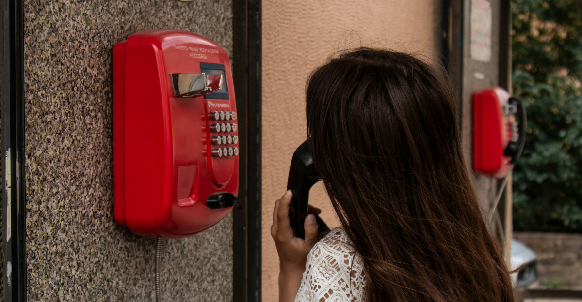 woman using payphone
