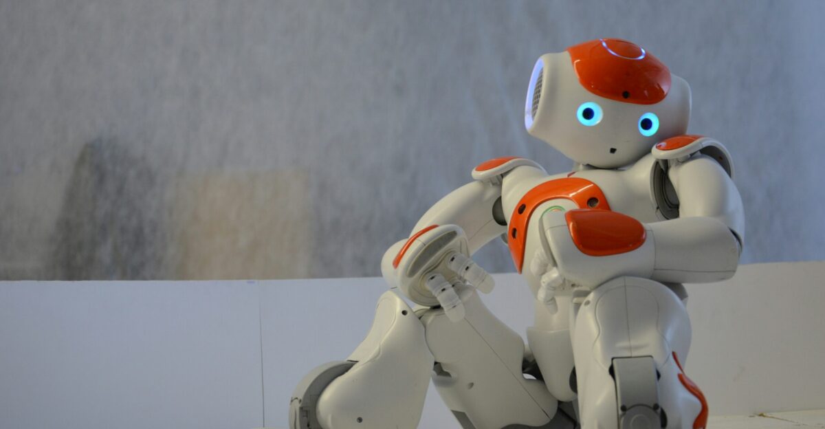 white and orange robot near wall