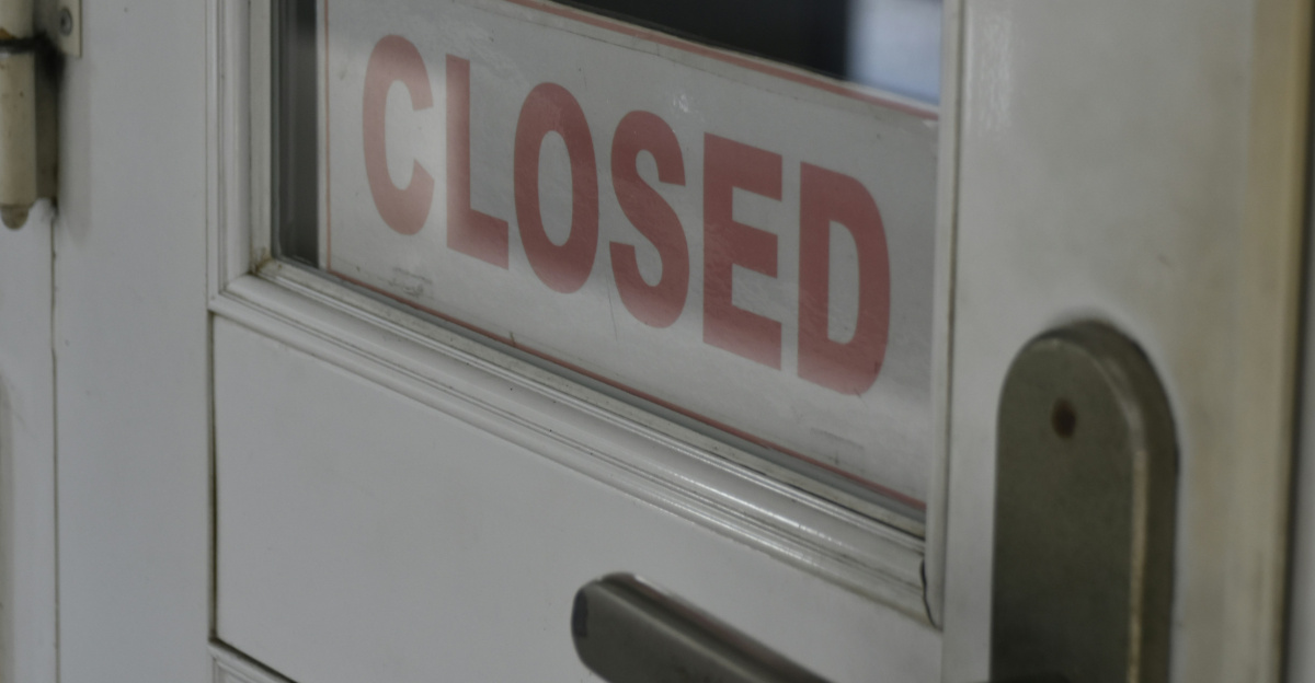 closed signage on white wooden half-glass door