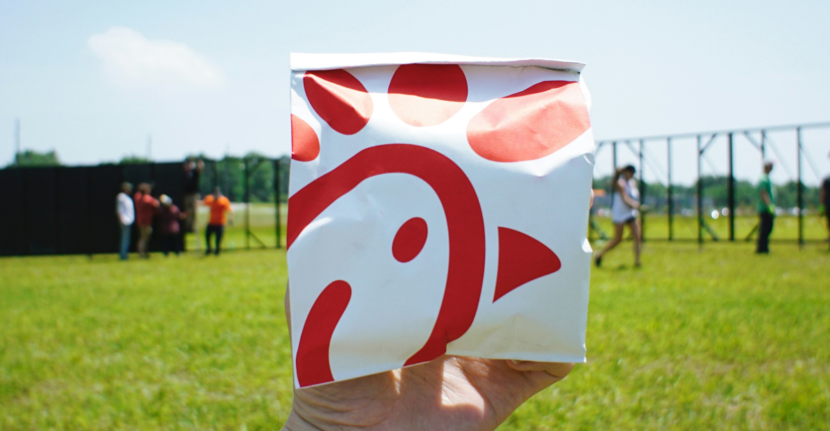 person holding white and red box
