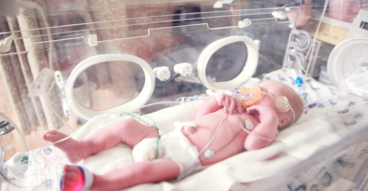 baby lying in incubator