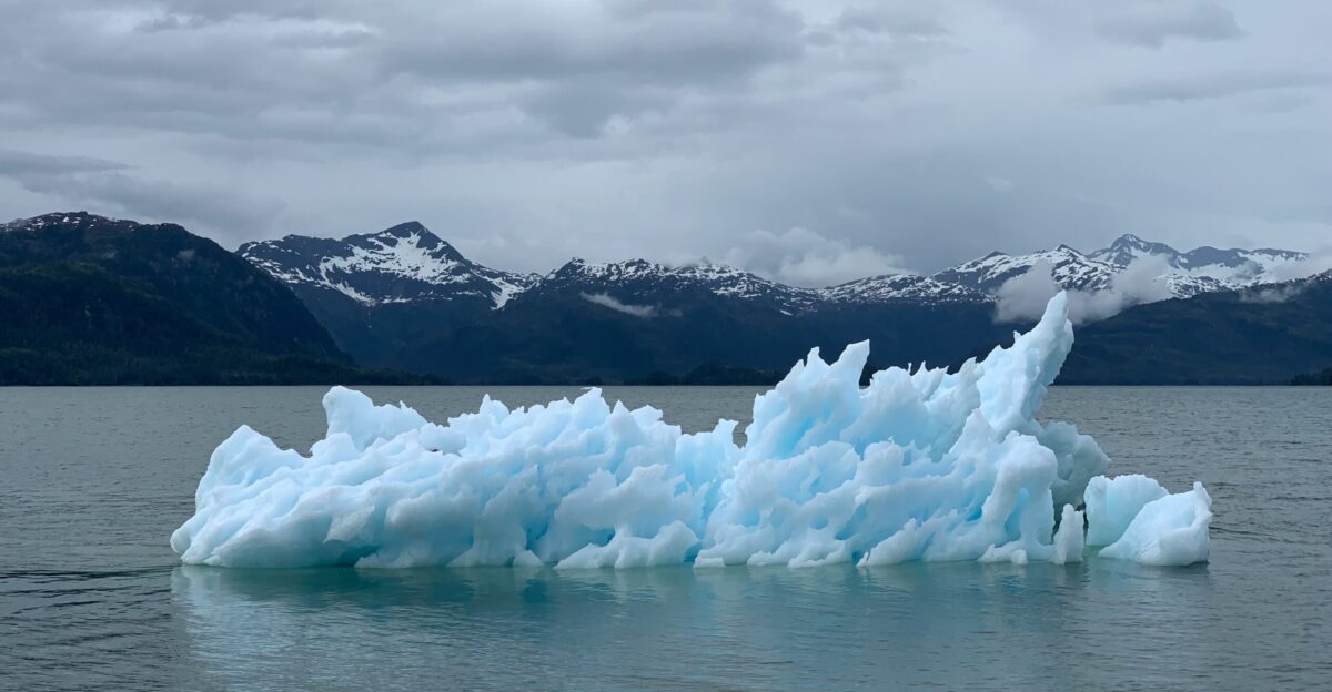 a large iceberg floating on top of a body of water