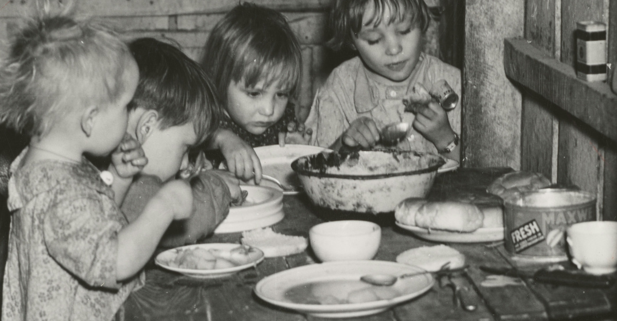 grayscale photography toddlers eating indoors