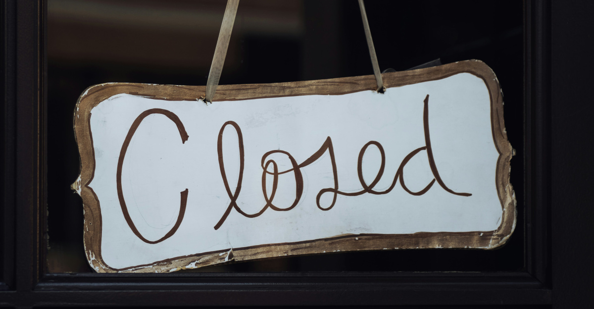 shallow focus photo of white closed signage