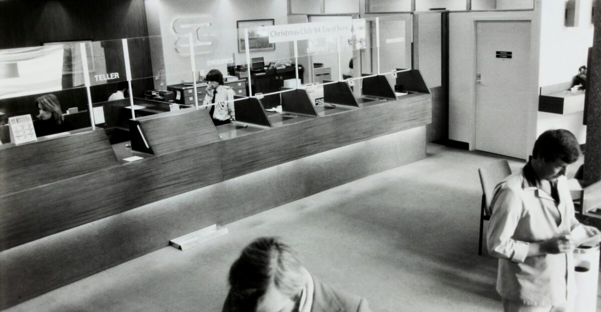 grayscale photo of man holding paper