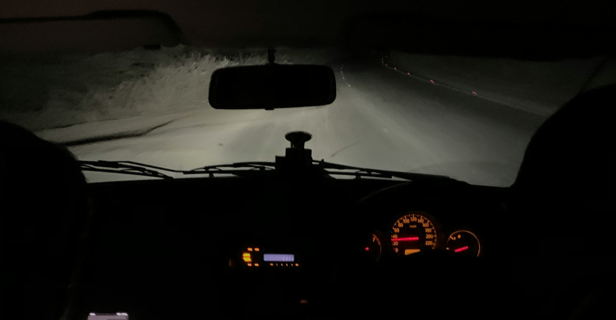a view of the dashboard of a car in the dark