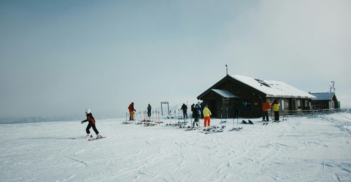 people on snowfield near house