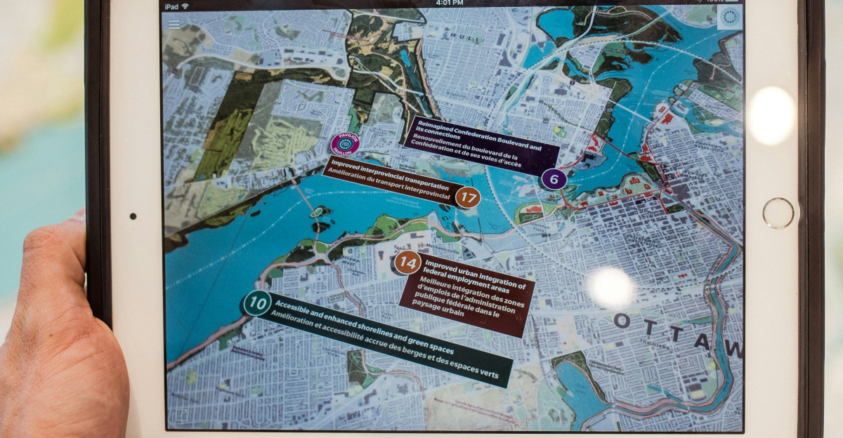 person holding white ipad with black case