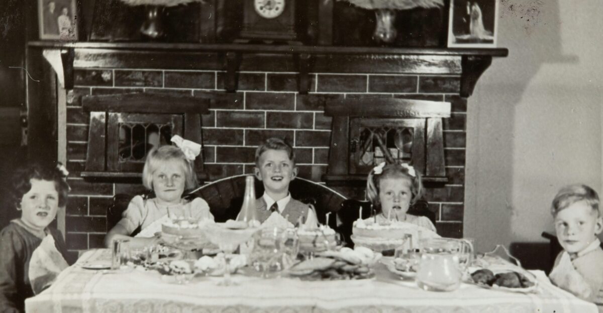 grayscale photo of family on table