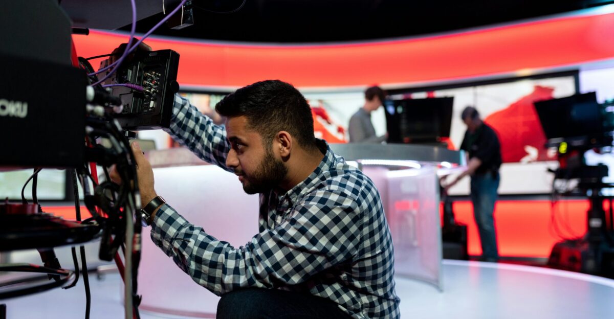 man in black and white checkered dress shirt sitting on chair