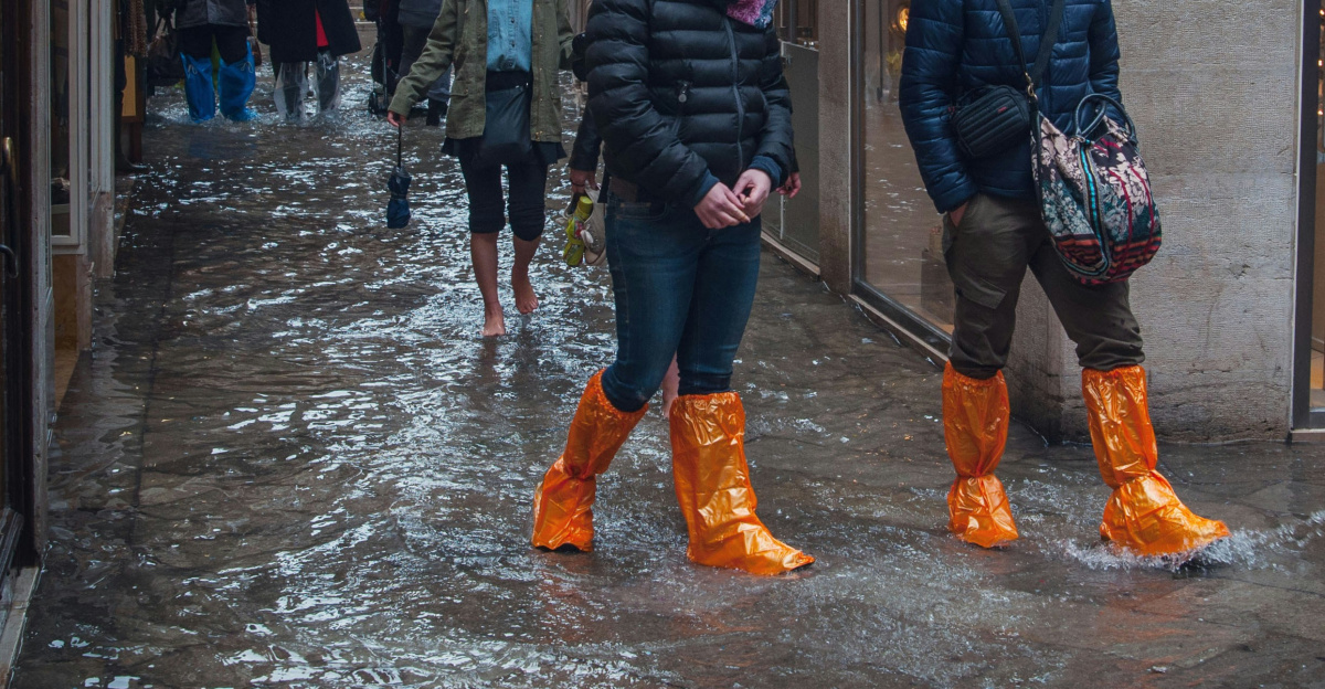 man in black jacket and brown pants walking on street during daytime