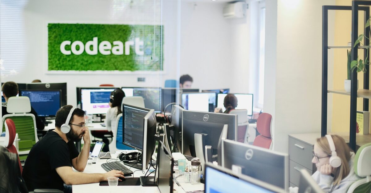 woman in black shirt sitting on chair using computer