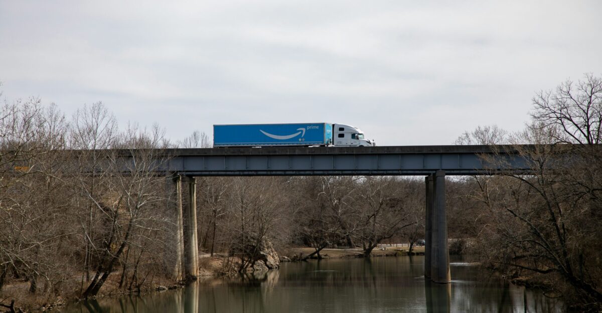 blue and white train on bridge during daytime
