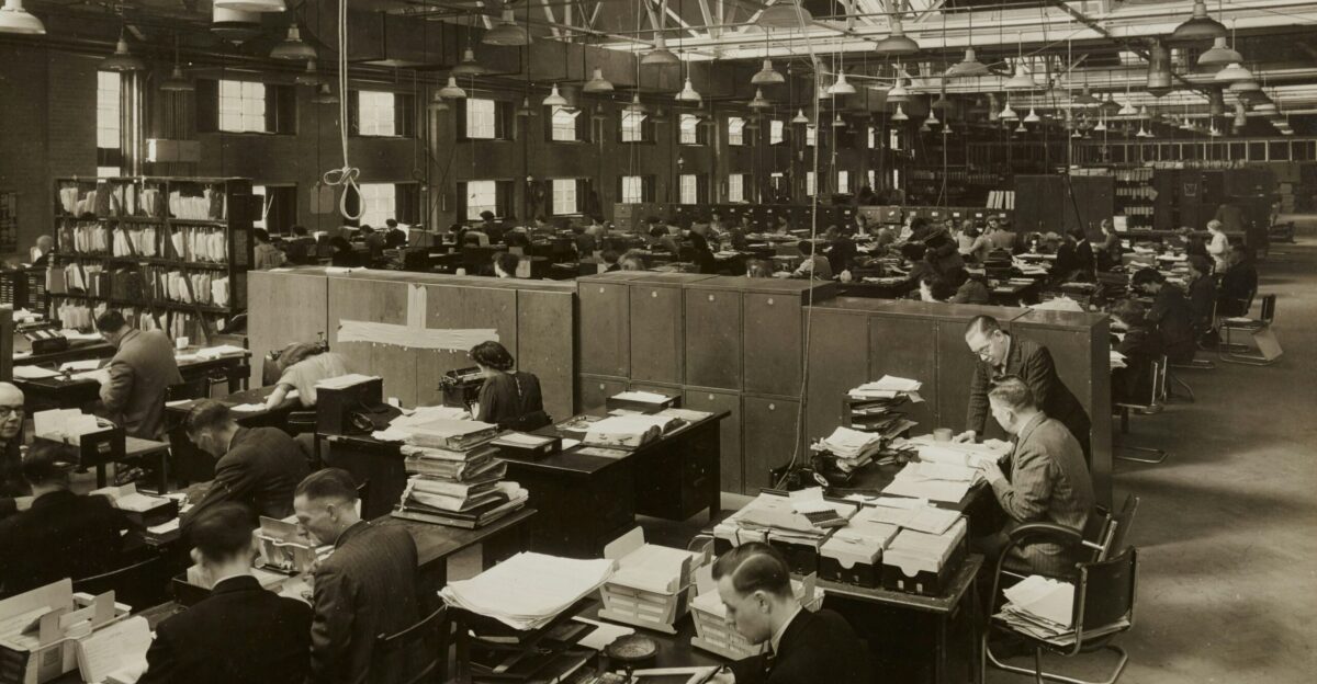 grayscale photo of man and woman sitting on chair