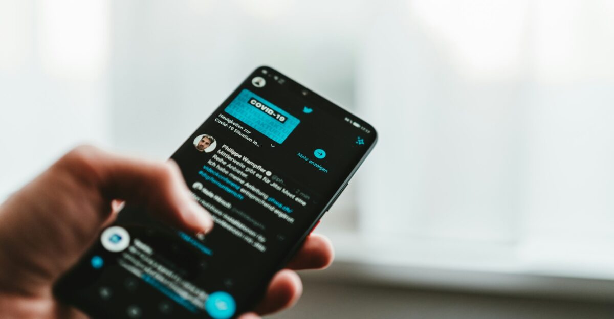 person holding black android smartphone