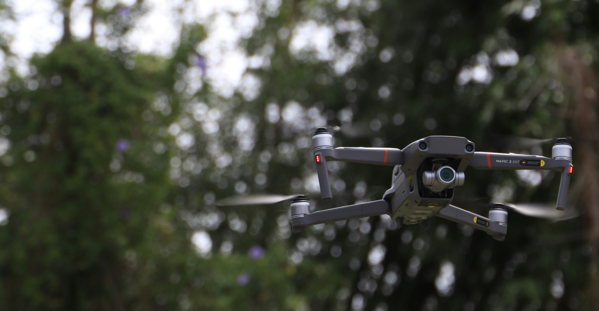 black and white drone flying in mid air during daytime