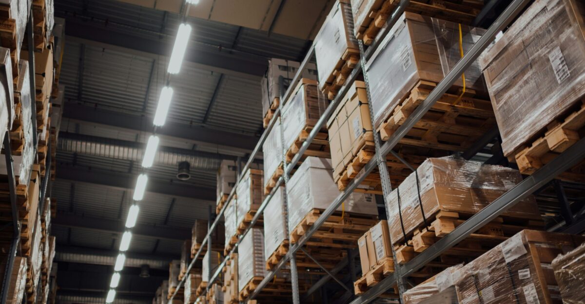 brown cardboard boxes on white metal rack