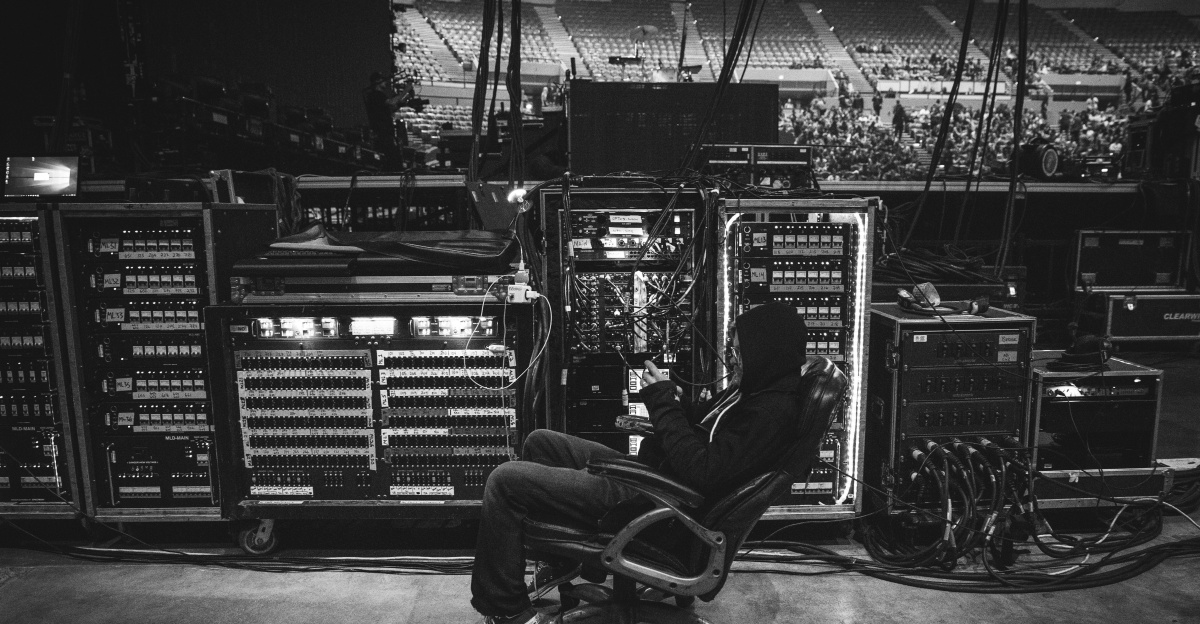 man in black shirt sitting on chair in front of computer