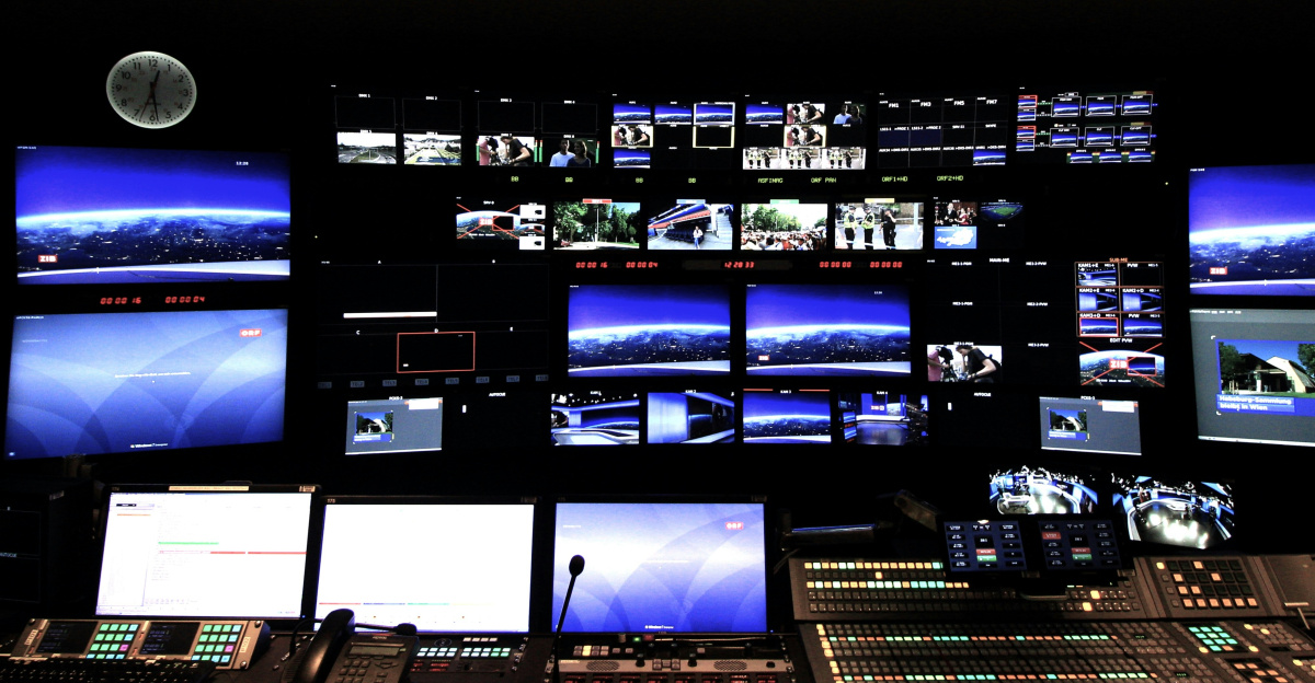 black laptop computer turned on near black flat screen computer monitor