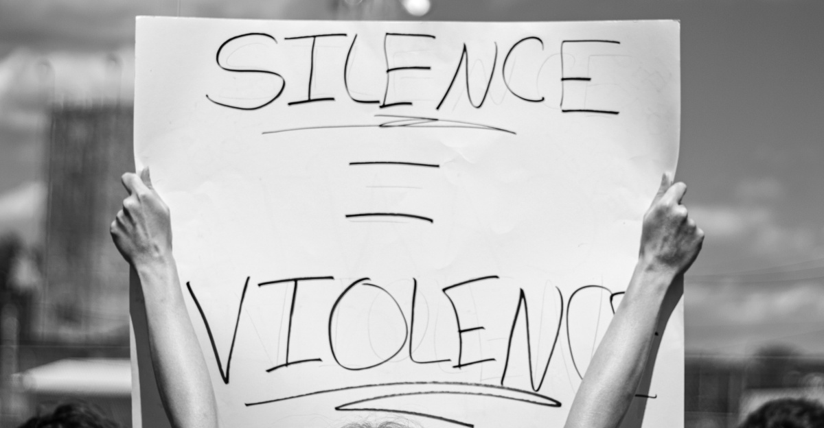 grayscale photo of 2 women holding white printer paper