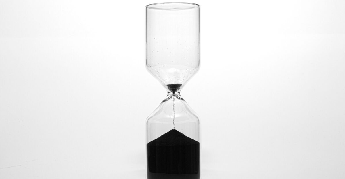 clear glass hour glass with black liquid