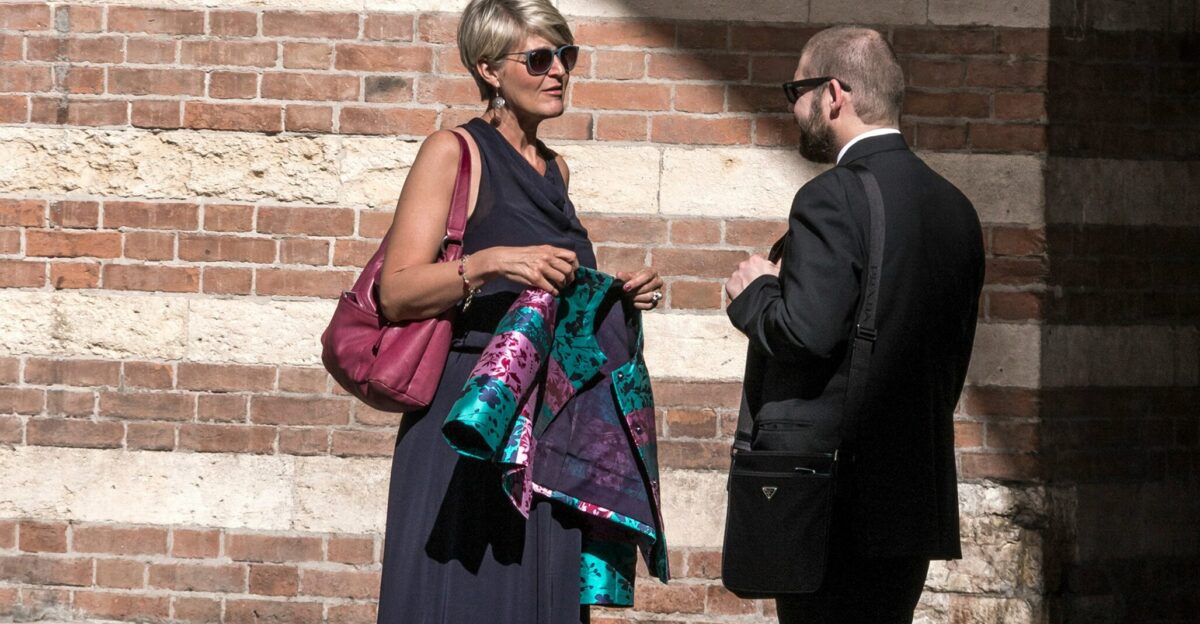 man in black suit standing beside woman in black dress