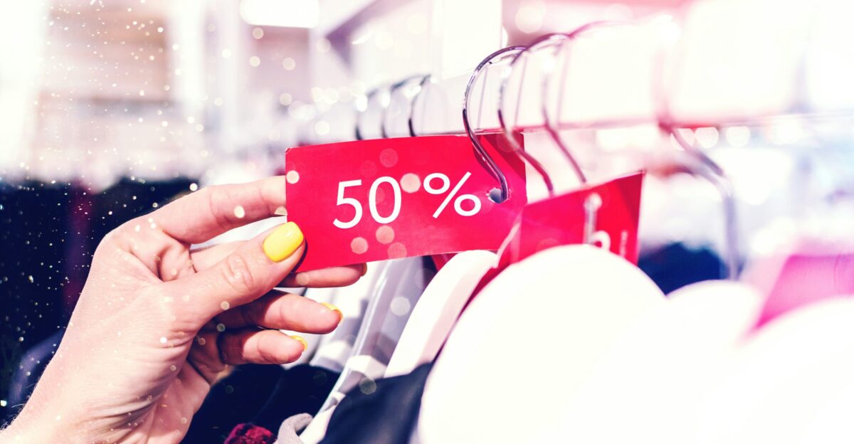 person holding red and white love print gift wrapper