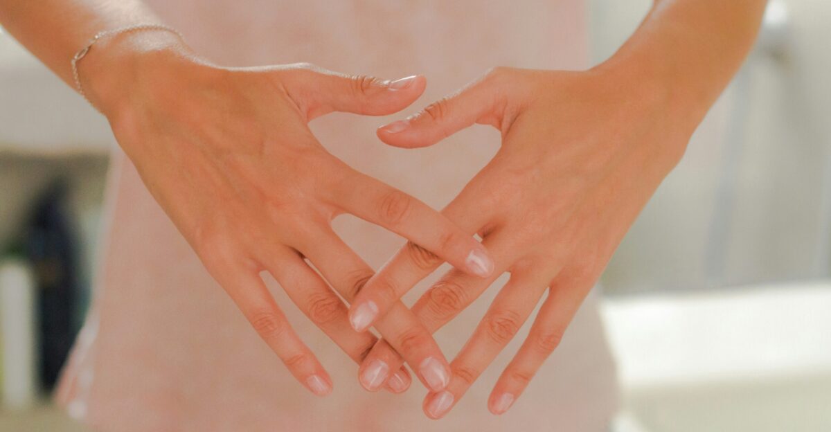 persons hand on white textile