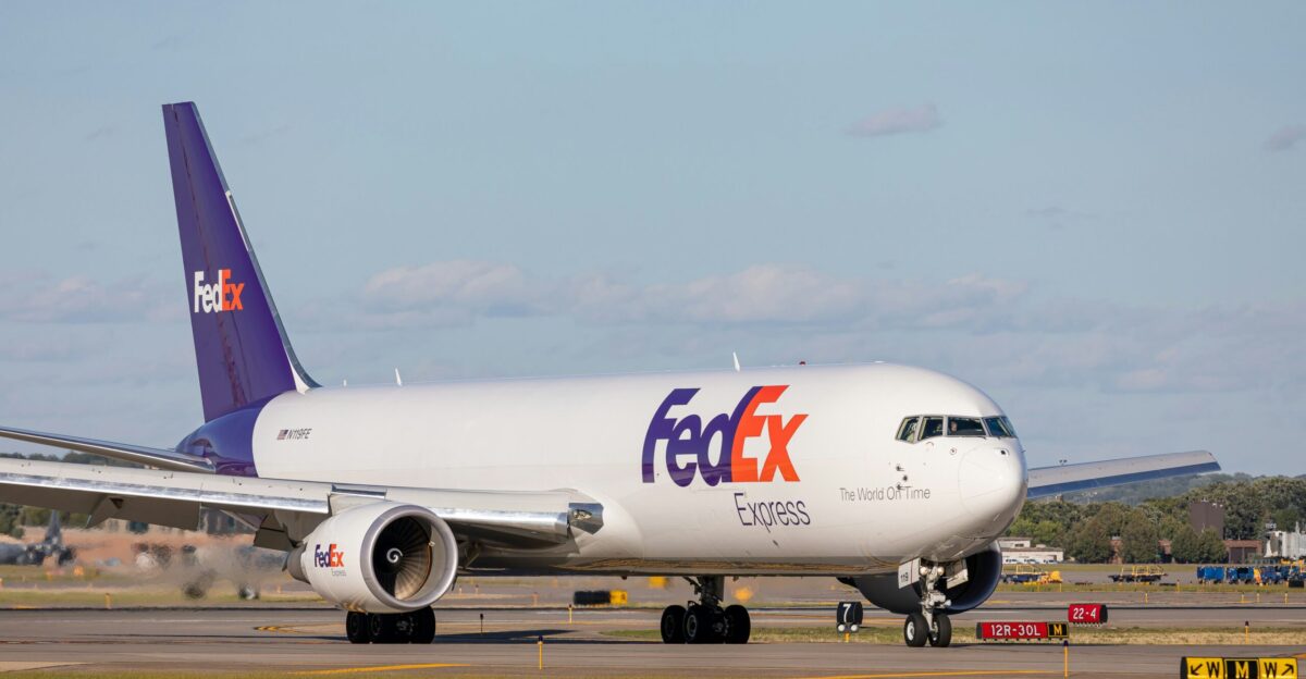 white and red passenger plane on airport during daytime