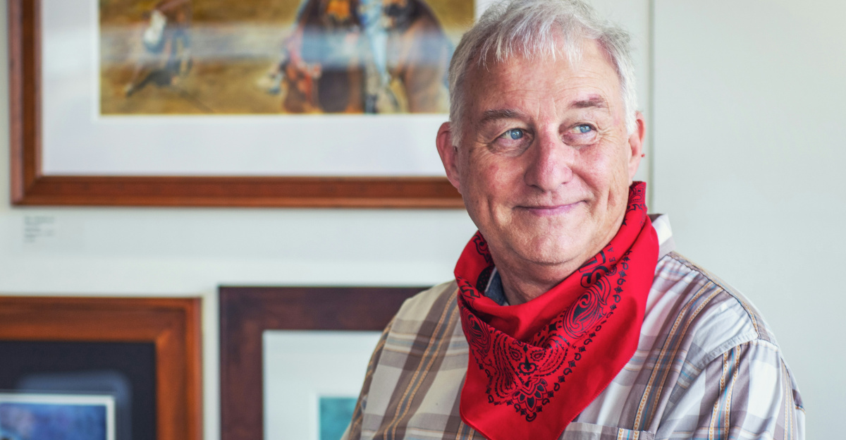 man in gray and white plaid dress shirt and red scarf