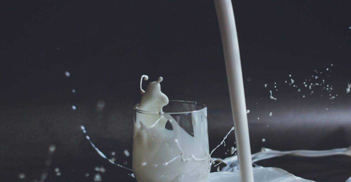 white candle in clear glass holder