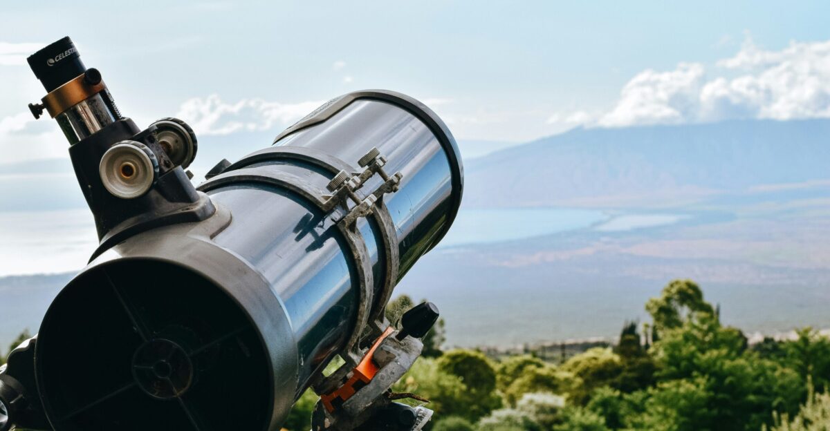 black and silver telescope on green grass field during daytime