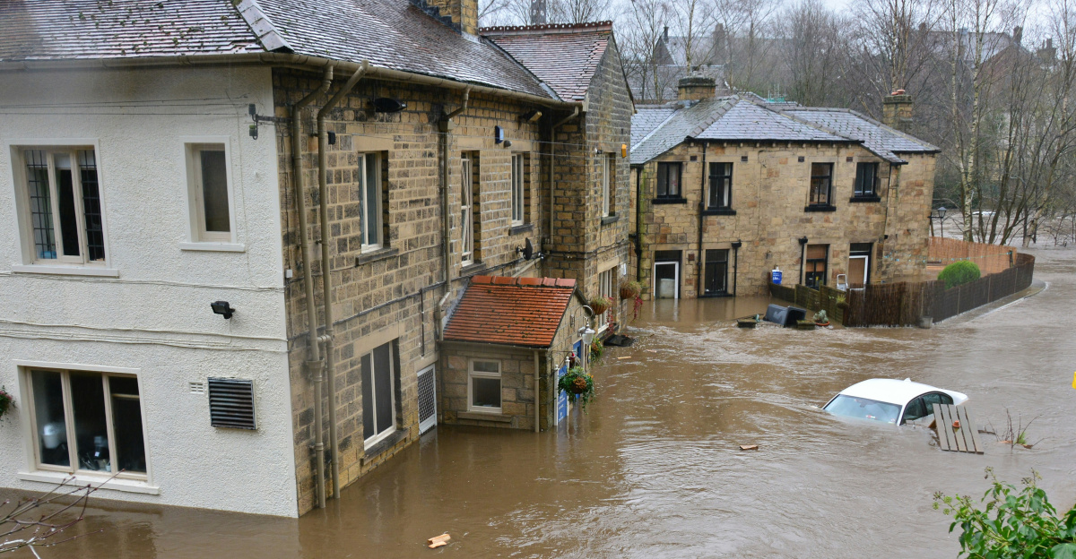 brown and white concrete house beside river during daytime