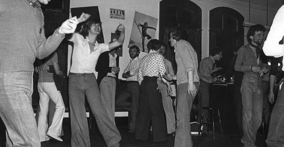 grayscale photo of man in white shirt and gray pants