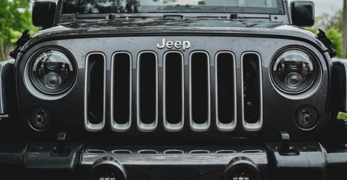 black and white car in front of green tree during daytime