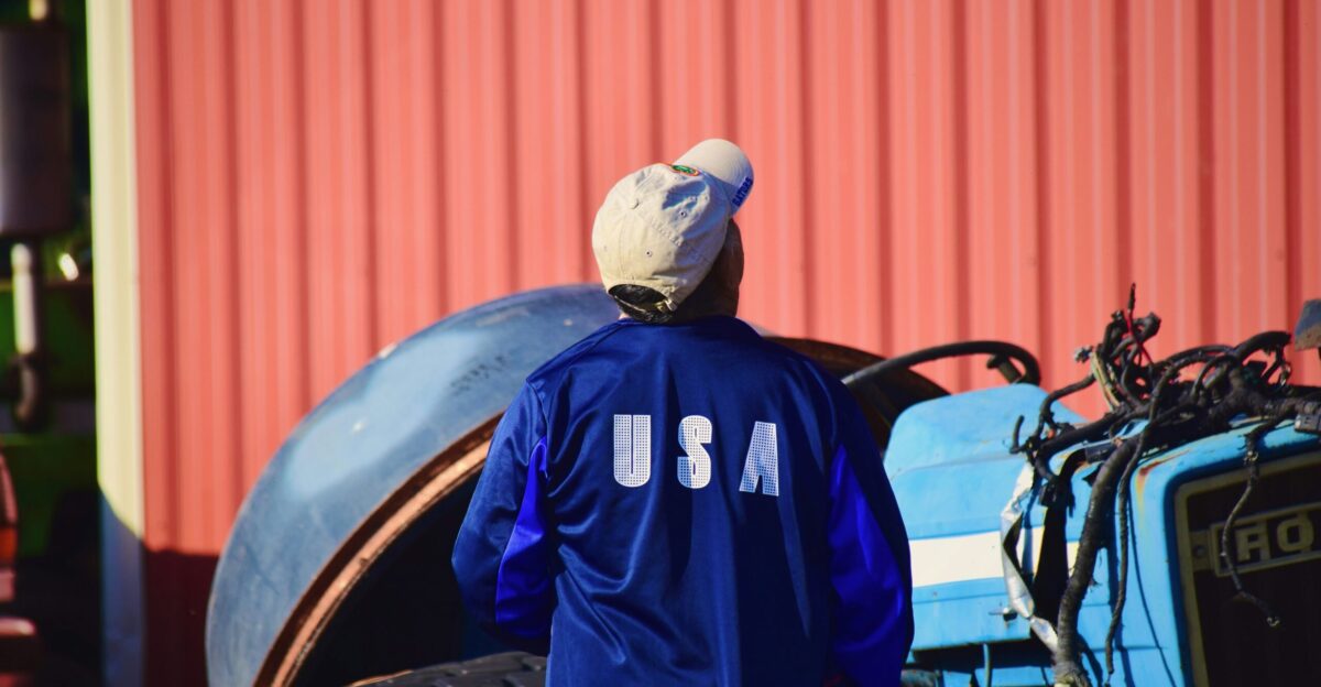 man in blue and black adidas jacket wearing white cap