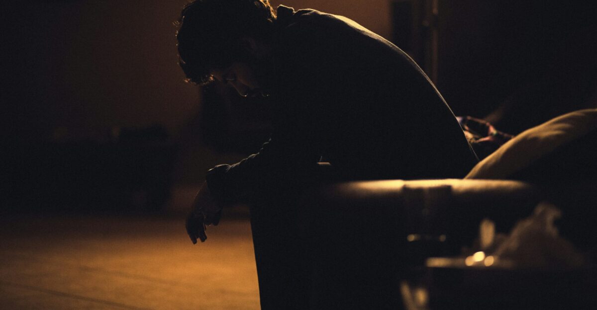 man in black shirt sitting on chair