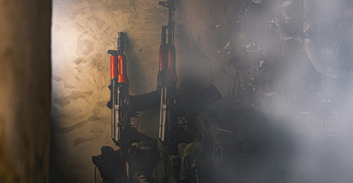 black and red rifle on black surface