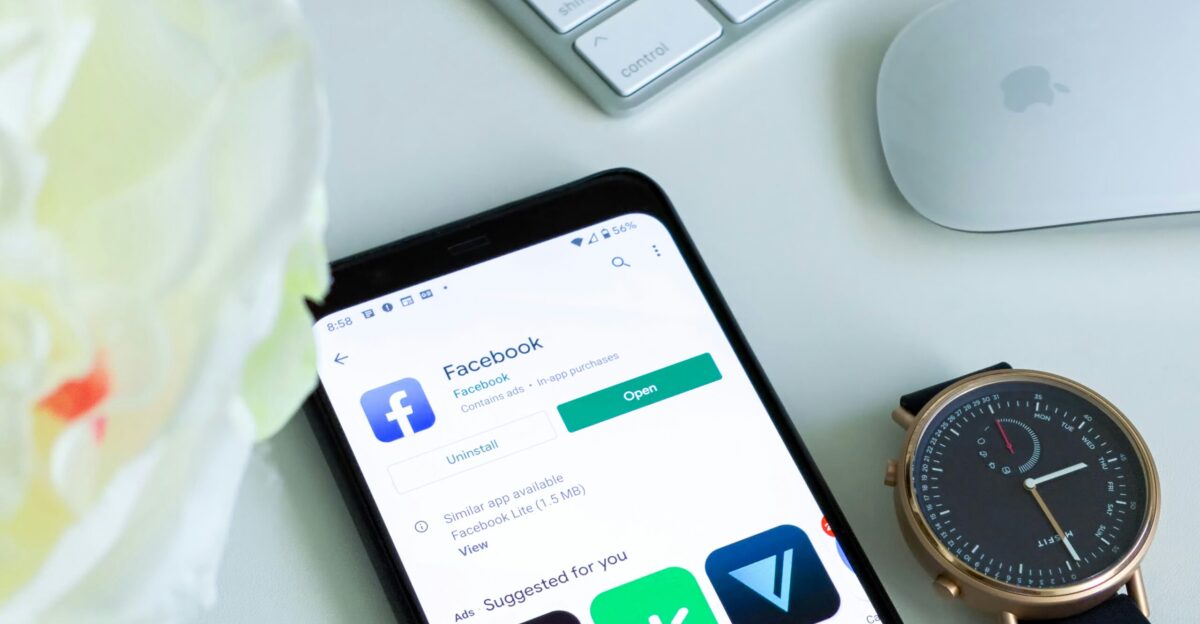 black android smartphone beside silver and gold round analog watch