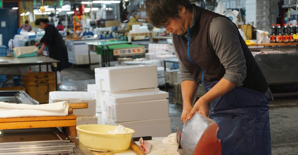 man in black crew neck t-shirt holding white plastic bag