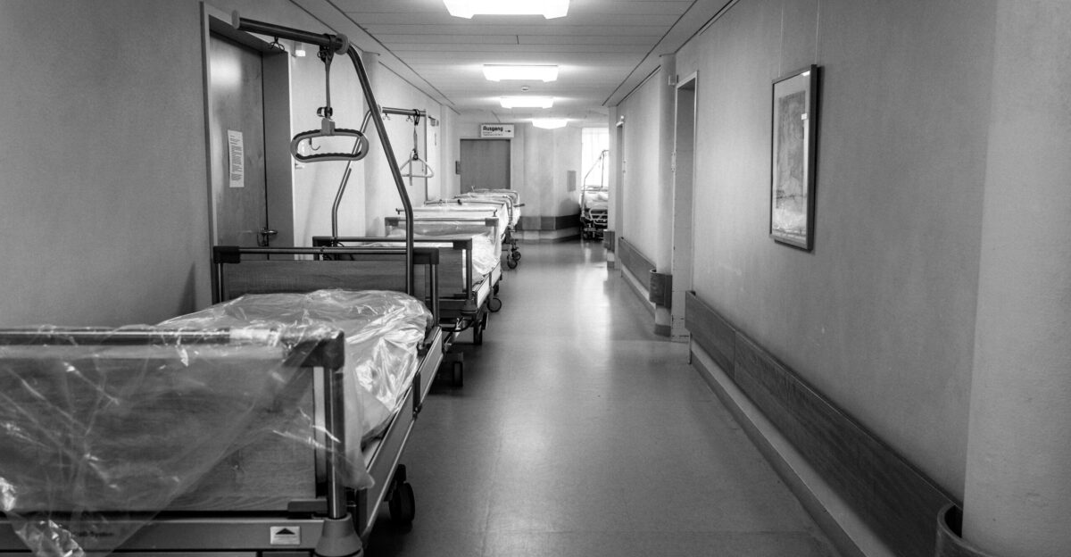 grayscale photo of hospital bed