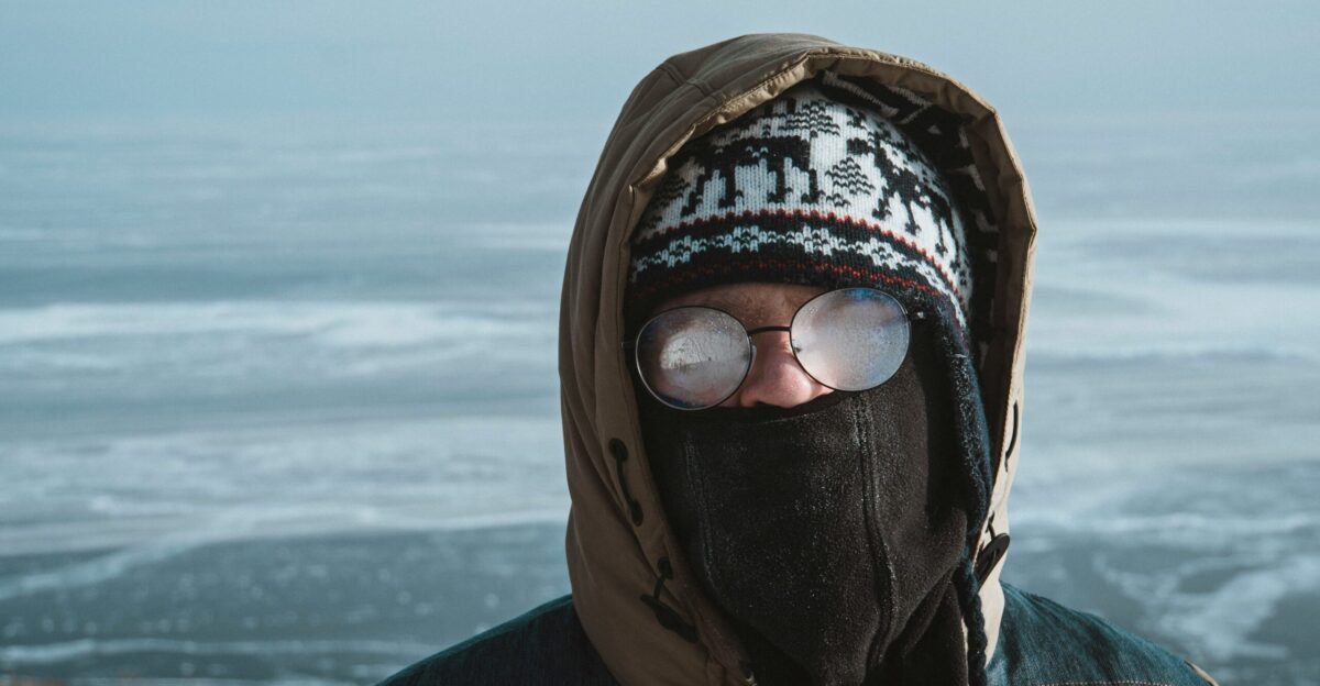 person wearing black and white knit cap and black jacket