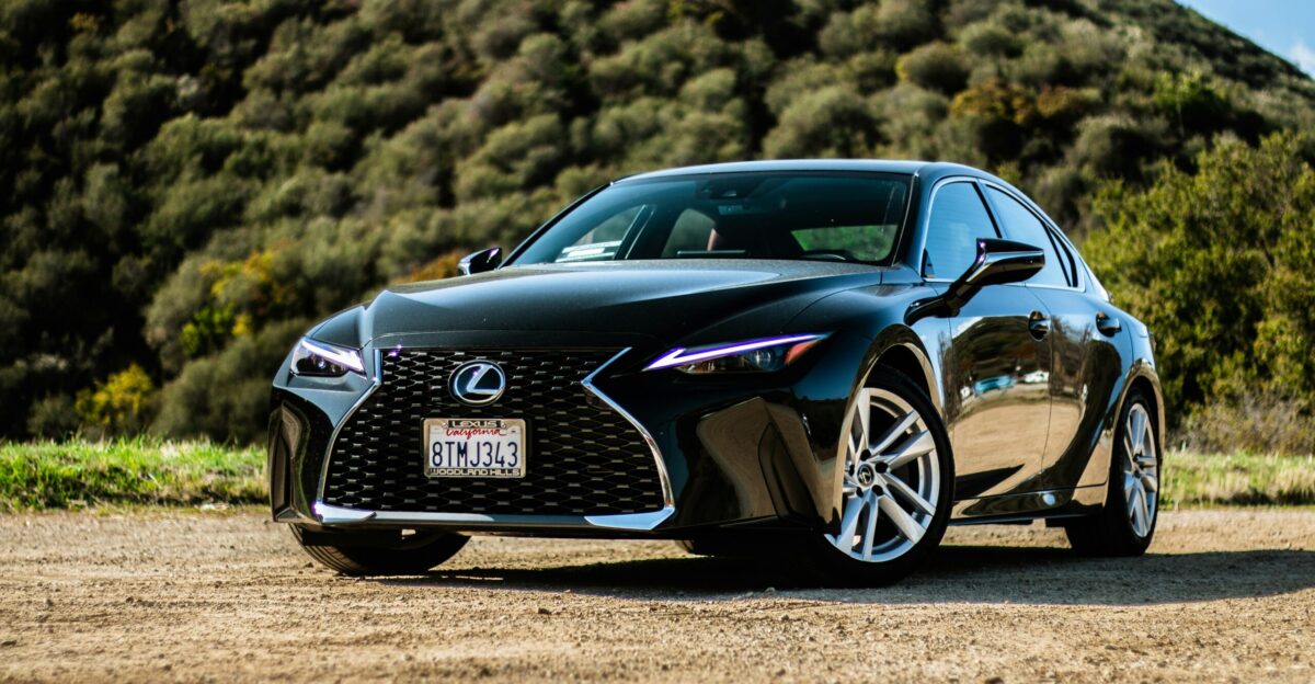 black porsche 911 on brown field during daytime