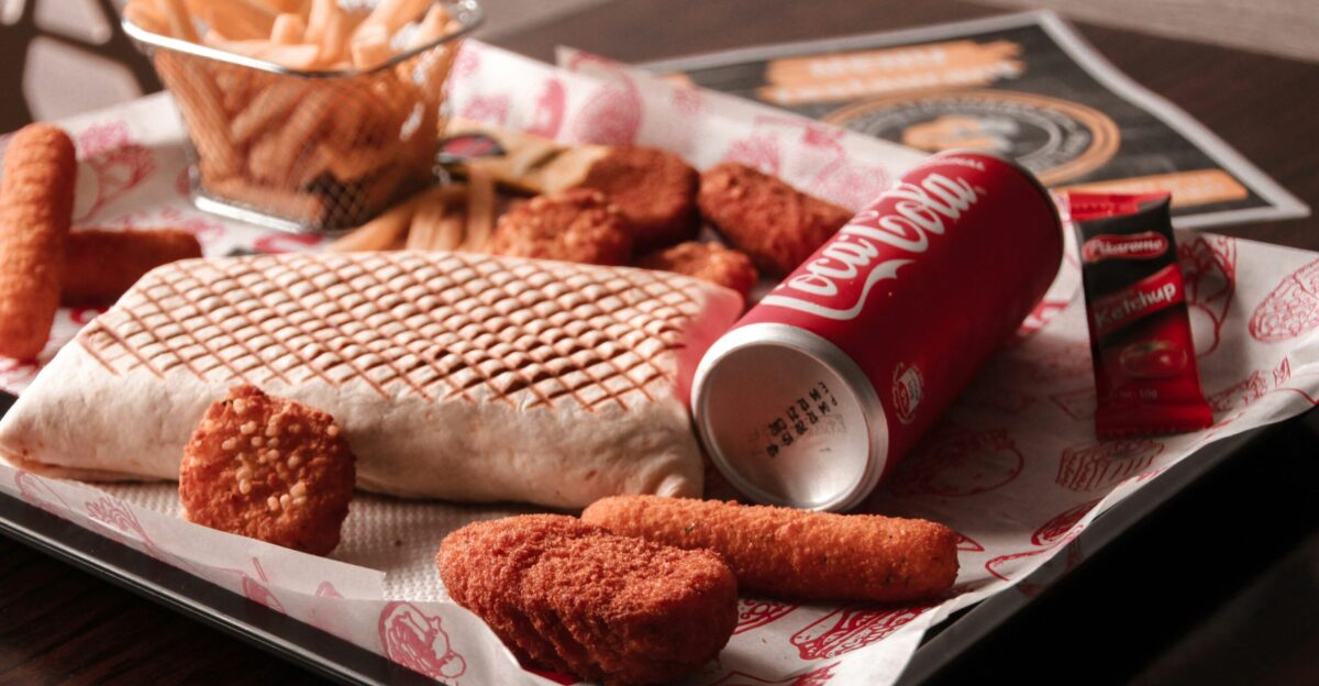 red and white coca cola can beside brown bread on white ceramic plate