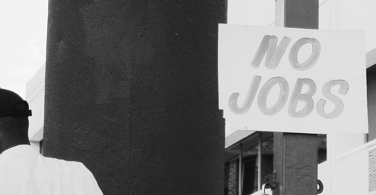 man in white dress shirt standing near white and black camera