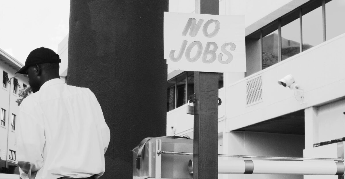 man in white dress shirt standing near white and black camera